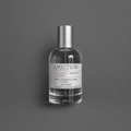 Ambition de Elixir Amador: frasco cilíndrico de 120 ml sobre fondo gris.