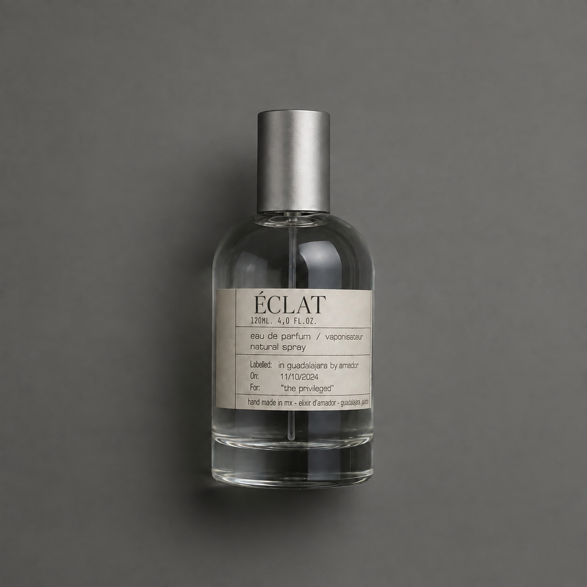Éclat de Elixir Amador: frasco cilíndrico de 120 ml sobre fondo gris.
