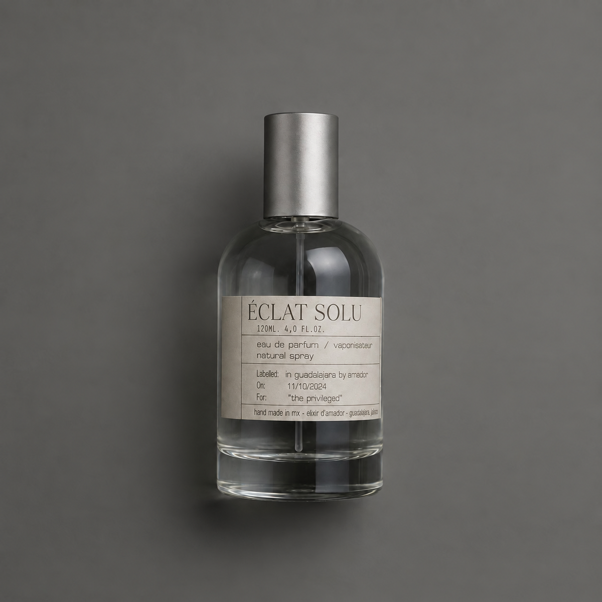 Éclat Solu de Elixir Amador: frasco cilíndrico de 120 ml sobre fondo gris.