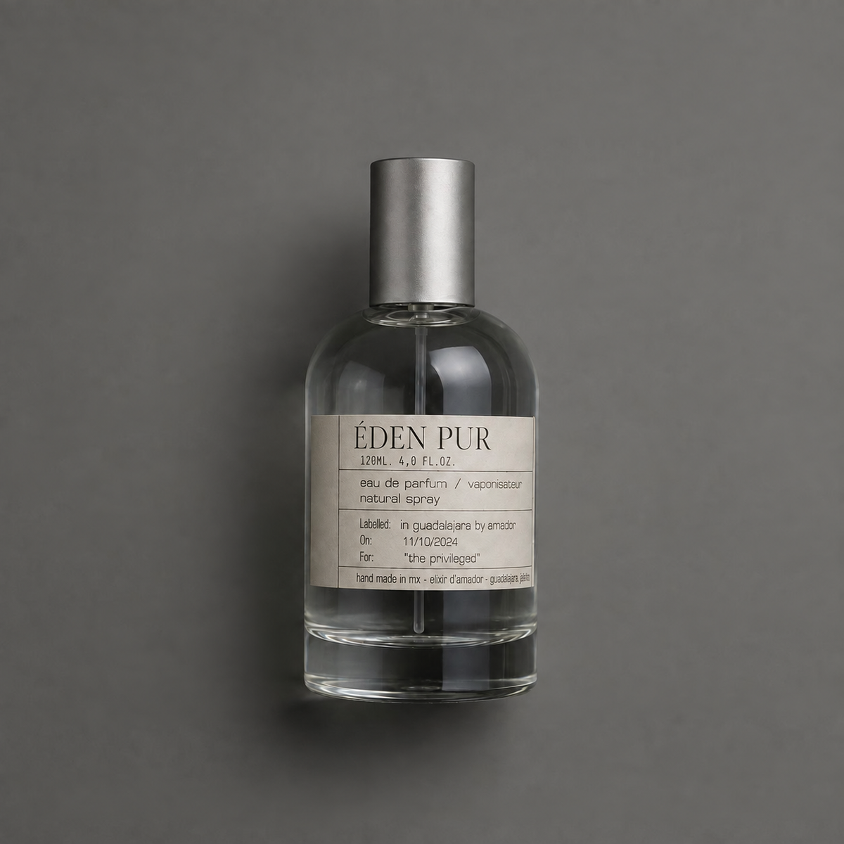 Éden Pur de Elixir Amador: frasco cilíndrico de 120 ml sobre fondo gris.