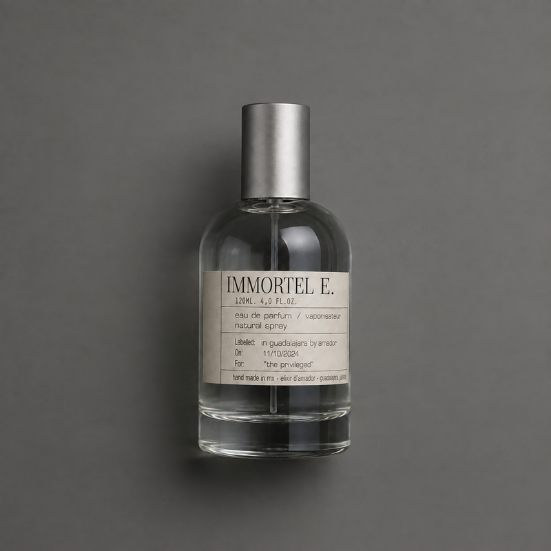 Immortel E. de Elixir Amador: frasco cilíndrico de 120 ml sobre fondo gris.